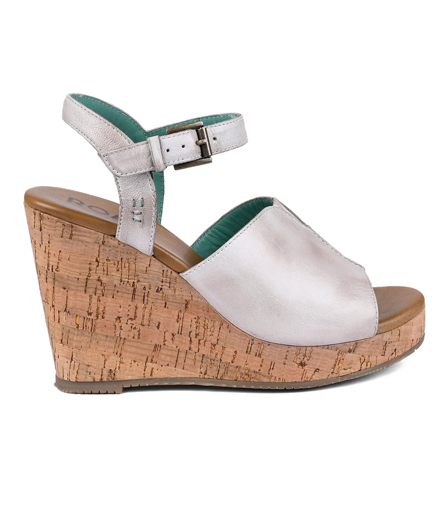 White Roan Deduction full-grain leather wedge sandal with a cork heel and a buckled ankle strap, isolated on a white background.