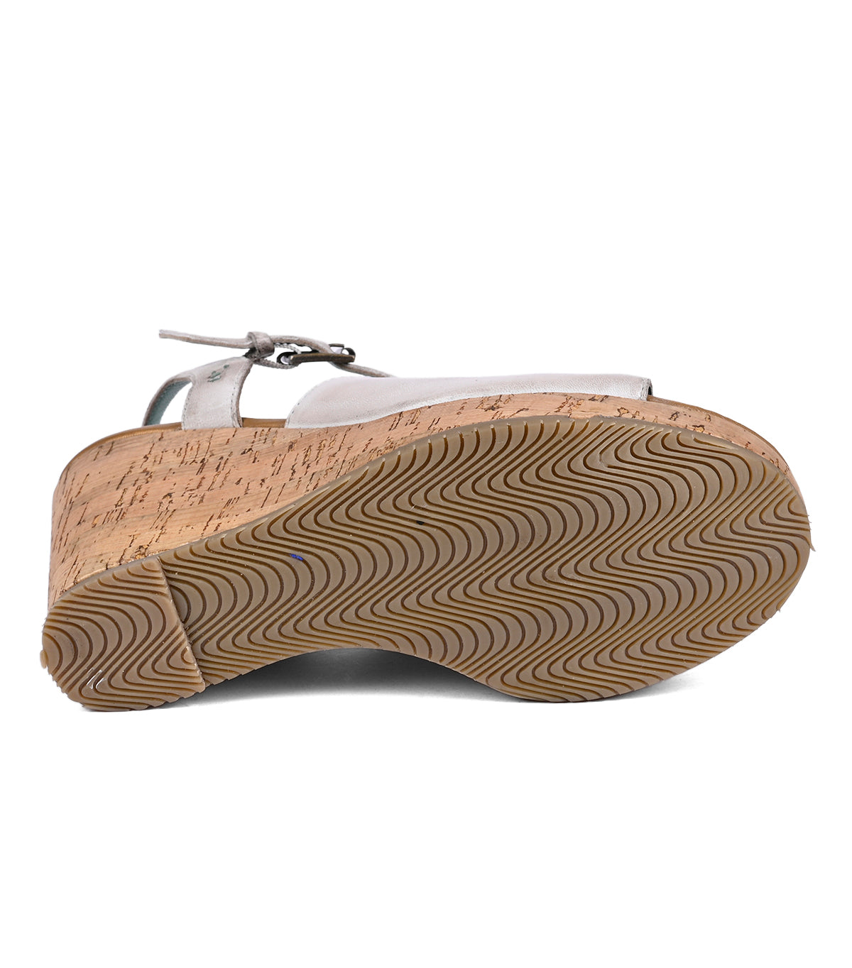
                  
                    Side view of Roan Deduction silver sandal with cork wedge heels and a brown rubber sole with a wavy pattern.
                  
                