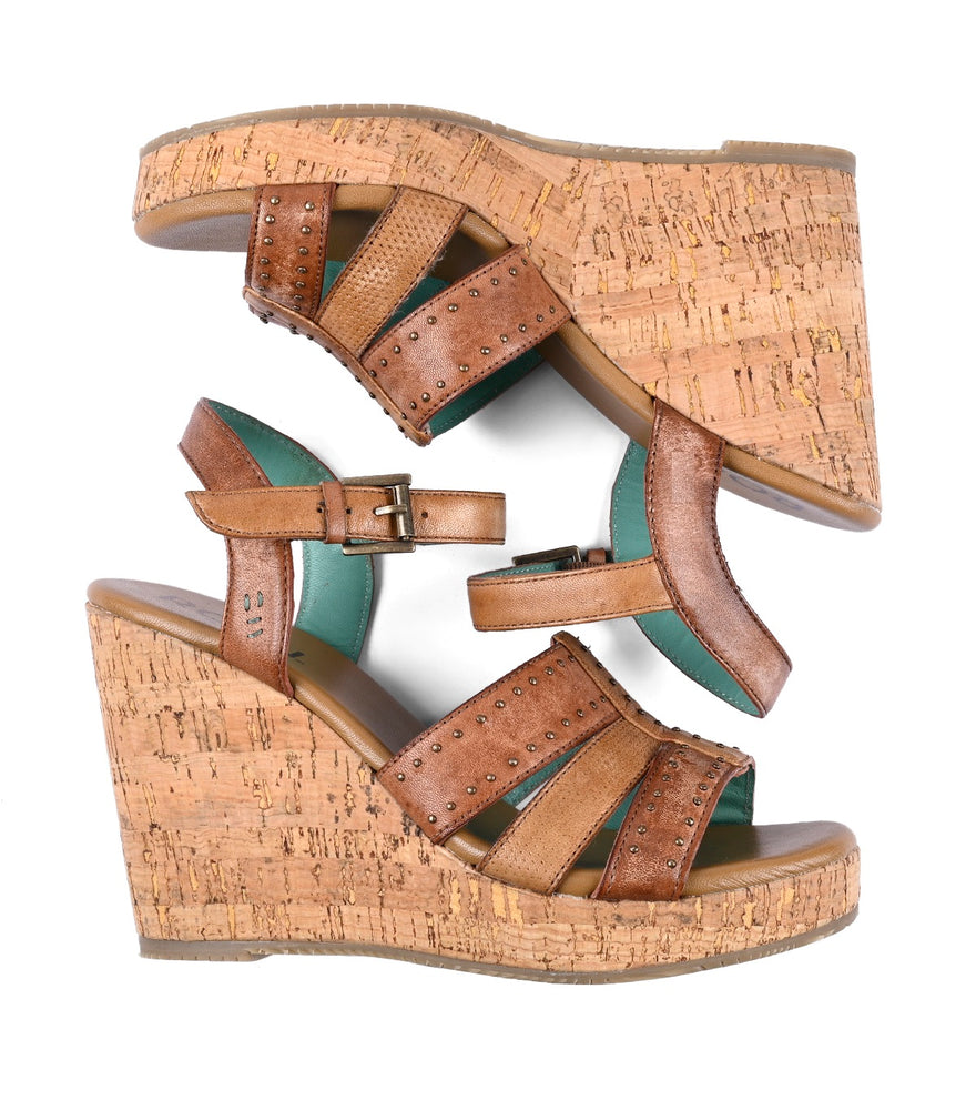 
                  
                    A pair of Different platform wedge sandals with cork heels and studded straps isolated on a white background.
                  
                