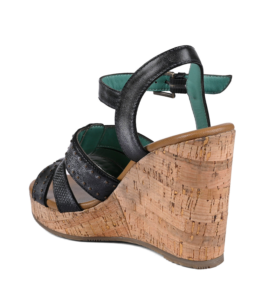 
                  
                    Side view of a black and green strappy women's Roan platform wedge sandal with a cork heel, isolated on a white background.
                  
                