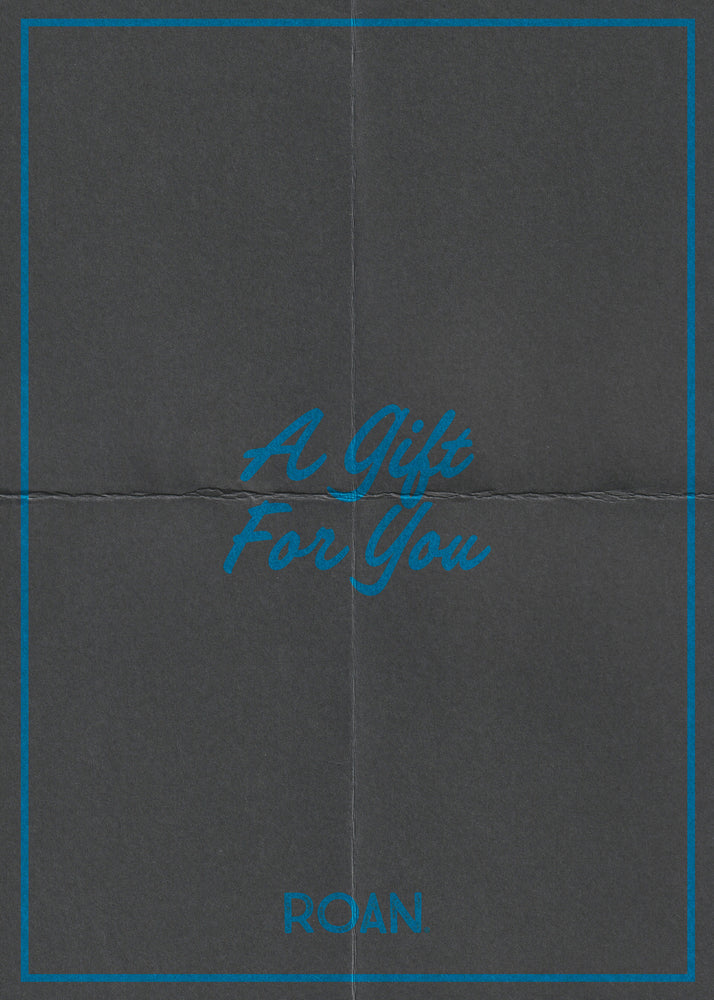 A dark gray "Just Because" eGift card from ROAN features blue borders, script text "A Gift For You," and "ROAN" at the bottom—redeemable online at roanfootwear.com.