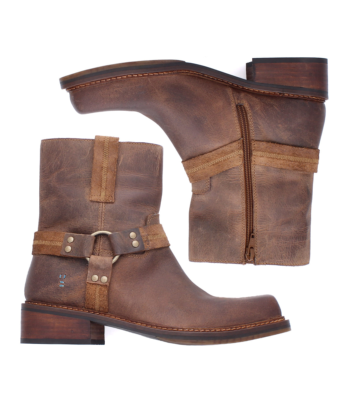 
                  
                    A pair of Roan Bonsai ankle boots crafted from brown full-grain leather, featuring side zippers, decorative harness straps, and low wooden heels, presented in side and top views.
                  
                