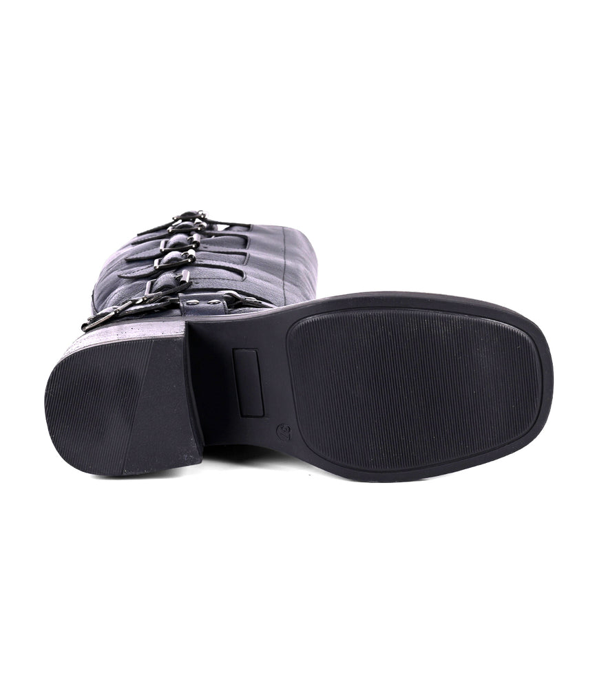
                  
                    Women's tall black leather boot with side buckles, bottom view
                  
                