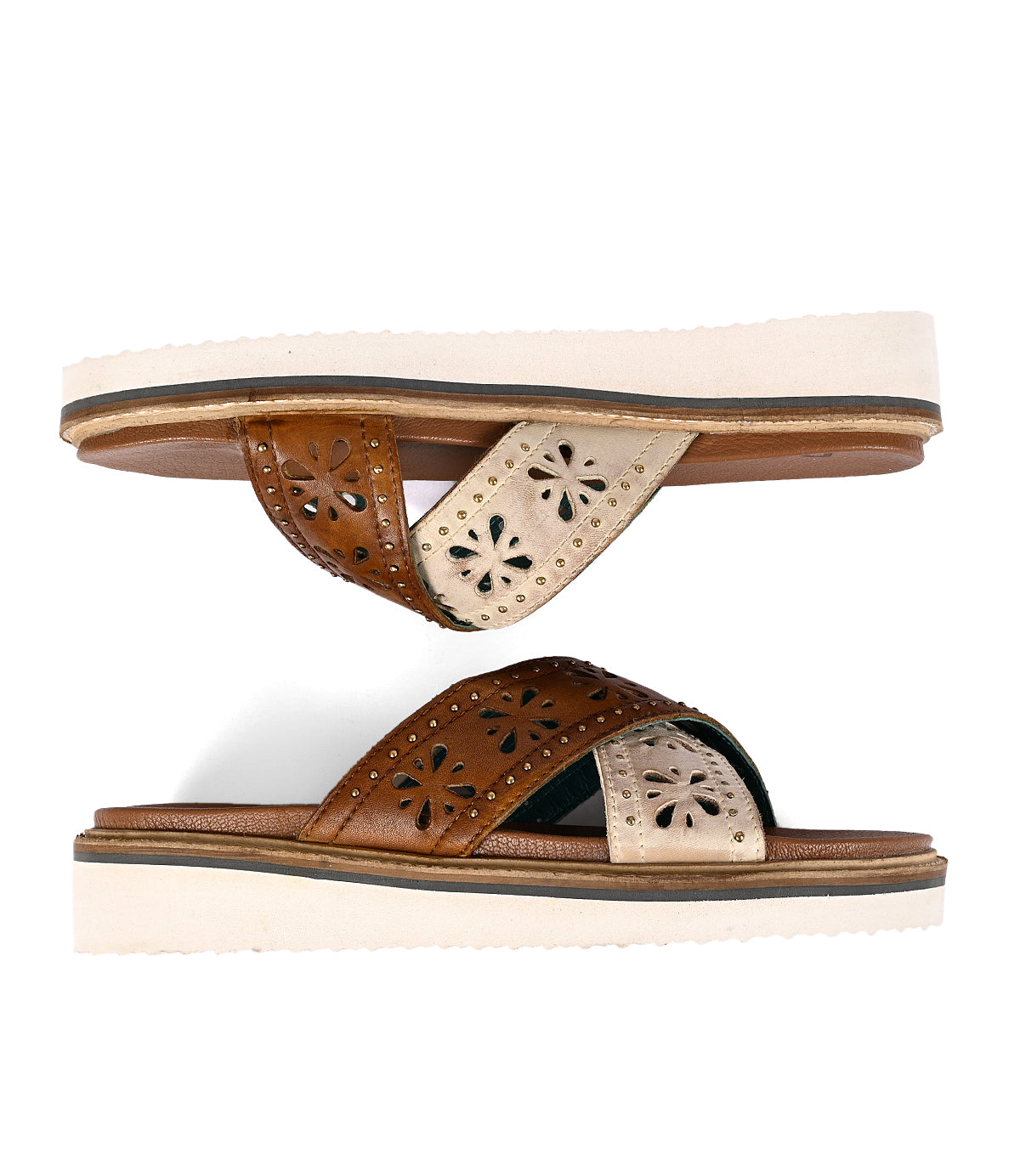 
                  
                    Brown leather sandals with decorative cut-outs and leather cross straps on a white background.
                  
                