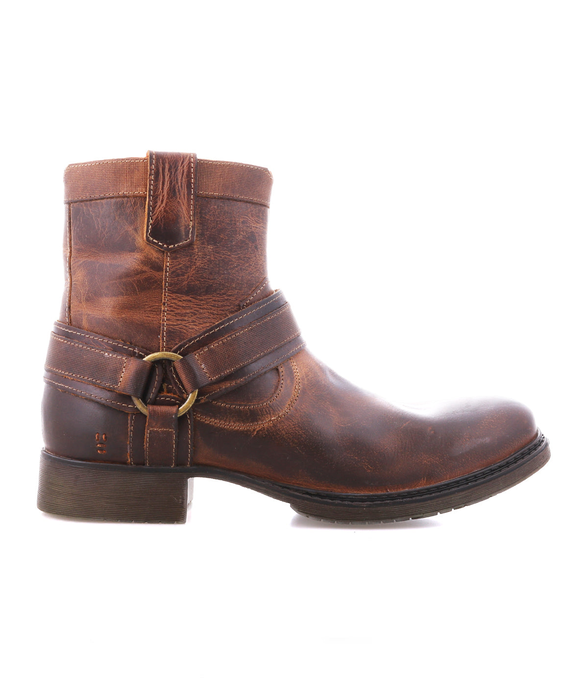 
                  
                    The Roan Colton II is a single brown leather ankle boot with a three-point harness, metal ring detail, low heel, and visible stitching, shown in profile on a white background.
                  
                