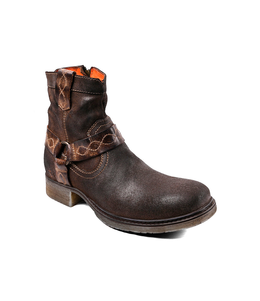 
                  
                    A brown leather Roan Colton V boot with a rugged harness strap and low heel, shown on a white background.
                  
                