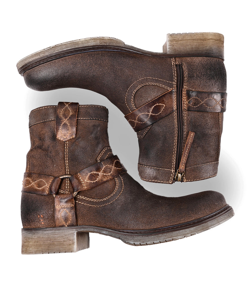
                  
                    The Roan Colton V boots—weathered suede with decorative straps, side zippers, and low block heels—are displayed on a white background.
                  
                