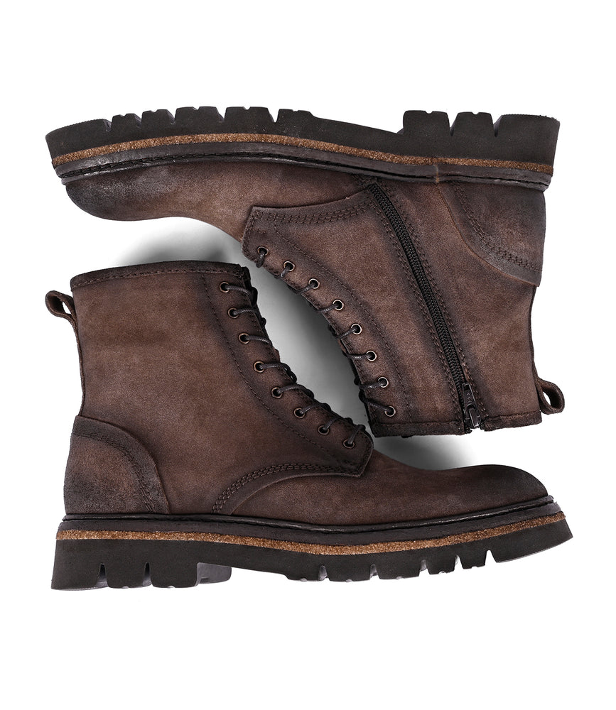 
                  
                    A pair of Roan's Duty boots in brown leather, featuring lace-up design with a padded insole and side zippers, perfectly complement their rugged soles when viewed from the side.
                  
                