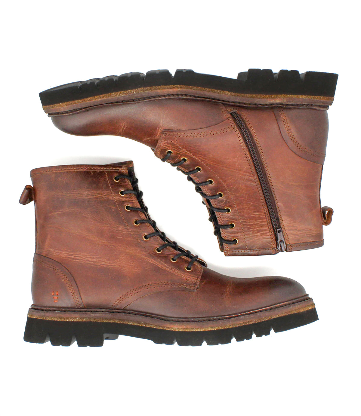 
                  
                    A pair of Roan Duty brown leather lace-up boots with side zippers, black rubber soles, and padded insoles are displayed side by side on a white background.
                  
                