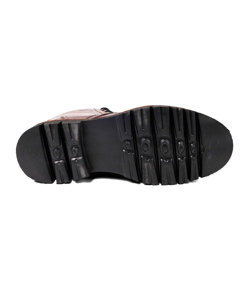 
                  
                    Close-up of the black rubber sole on the Roan Duty men's boot, featuring a textured tread pattern with horizontal grooves and circular designs.
                  
                