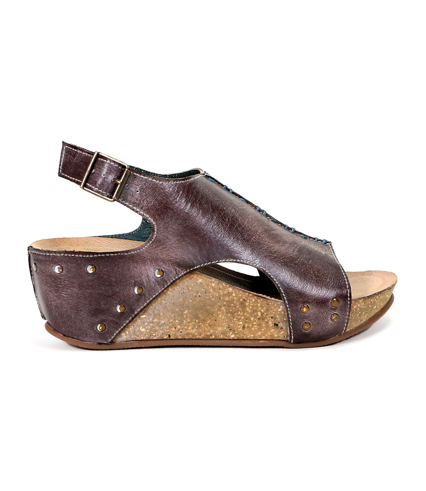 
                  
                    Fortnight brown full-grain leather wedge sandal with an ankle strap and studded accents, isolated on a white background.
                  
                