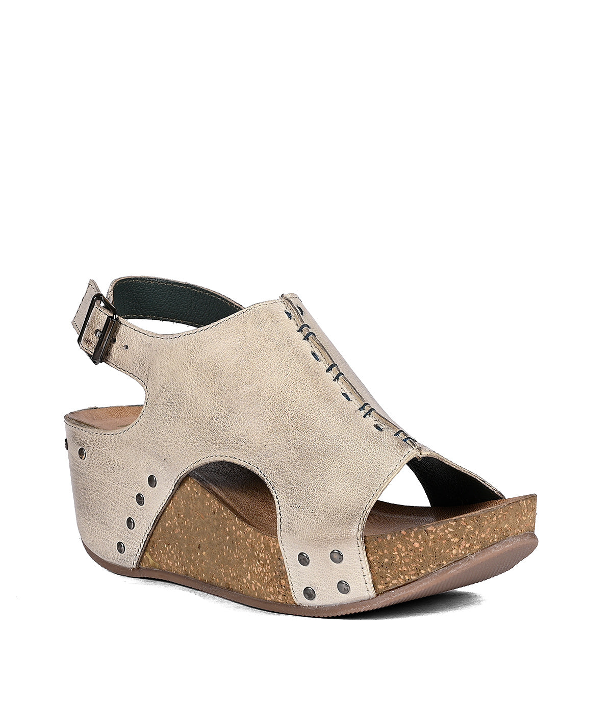 A beige full-grain leather wedge sandal with an ankle strap and decorative perforations along the side, displayed against a white background by Roan.