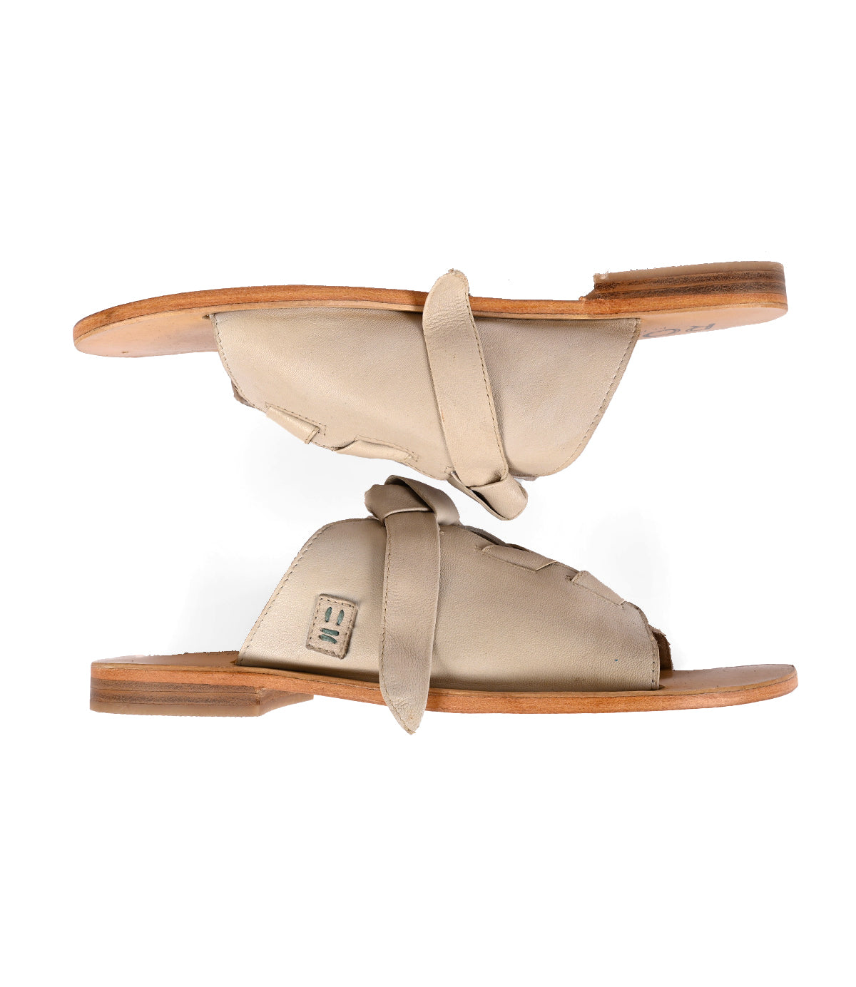 
                  
                    Pair of Roan Grapevine beige sandals with adjustable leather straps on a white background.
                  
                