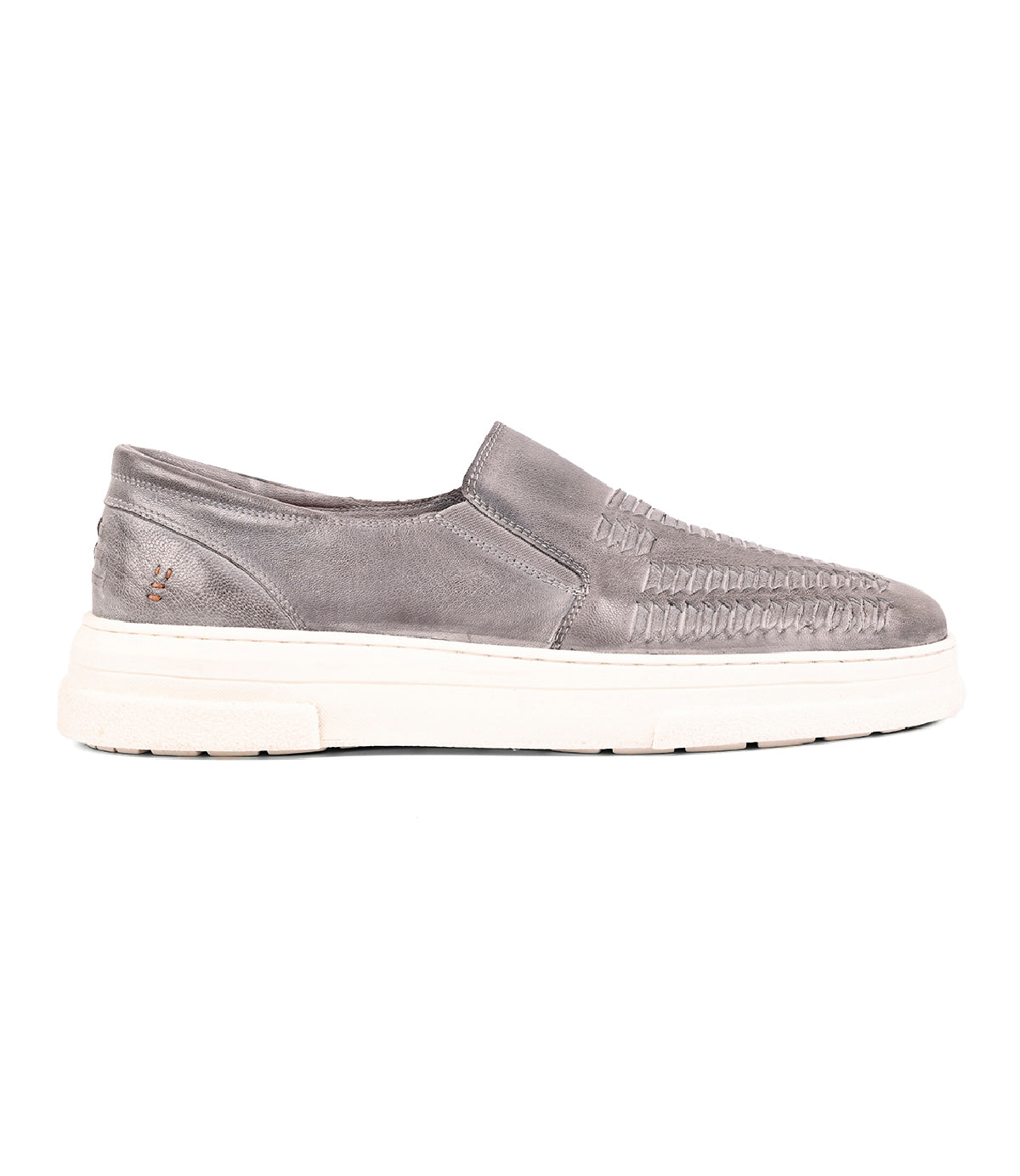 The Gregor by Roan is a gray slip-on sneaker made from handwoven goat leather with a washed finish, set on a thick white sole and shown in side profile against a white background.
