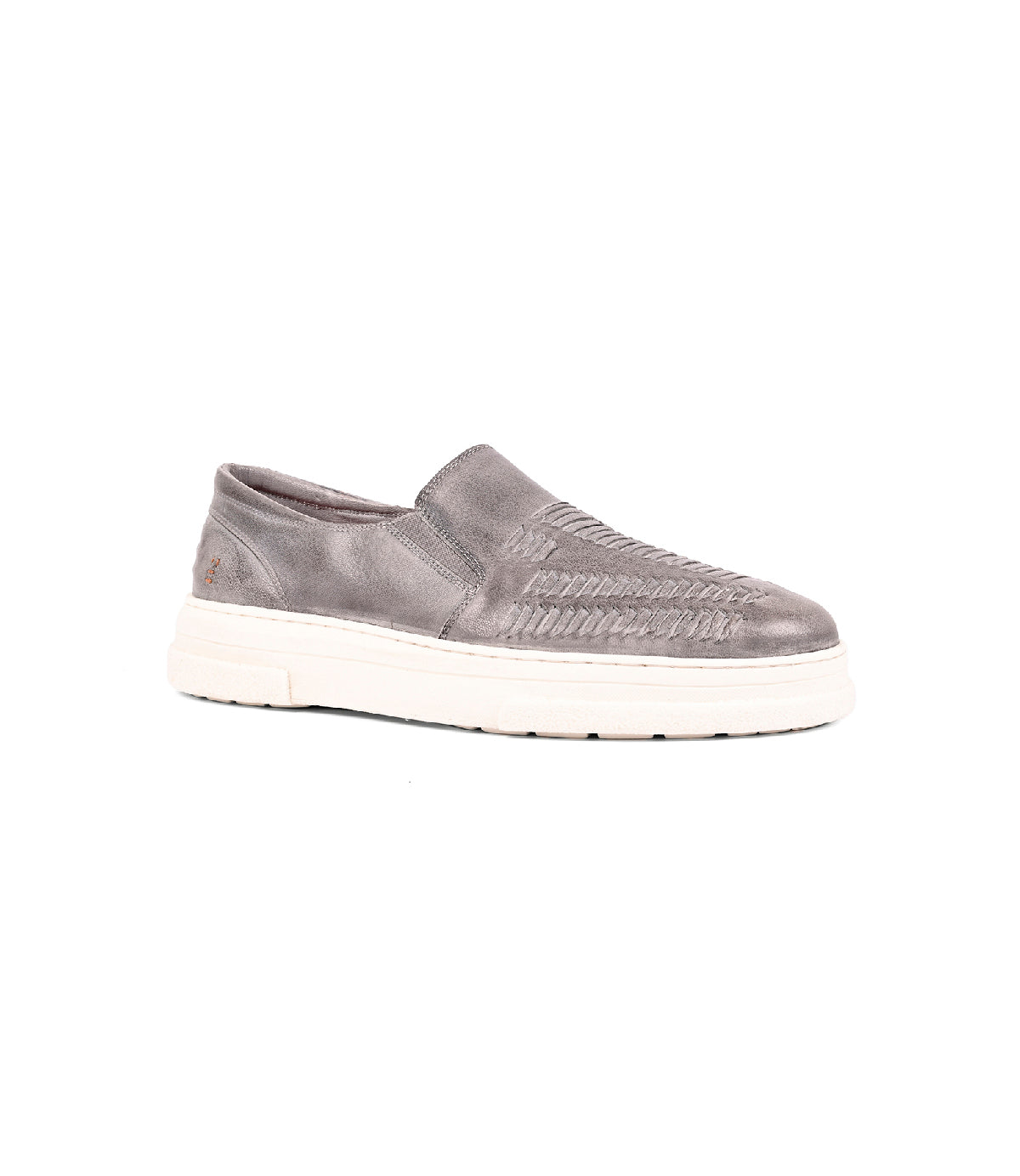 The Gregor by Roan is a gray slip-on shoe made from handwoven goat leather with a washed finish and thick white sole, shown on a plain white background.
