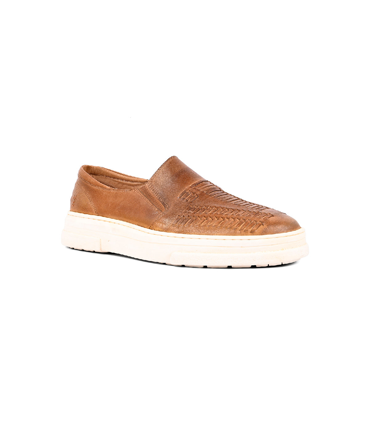 
                  
                    The Gregor by Roan is a brown slip-on crafted from handwoven goat leather with woven upper details and a thick white sole, shown on a white background.
                  
                