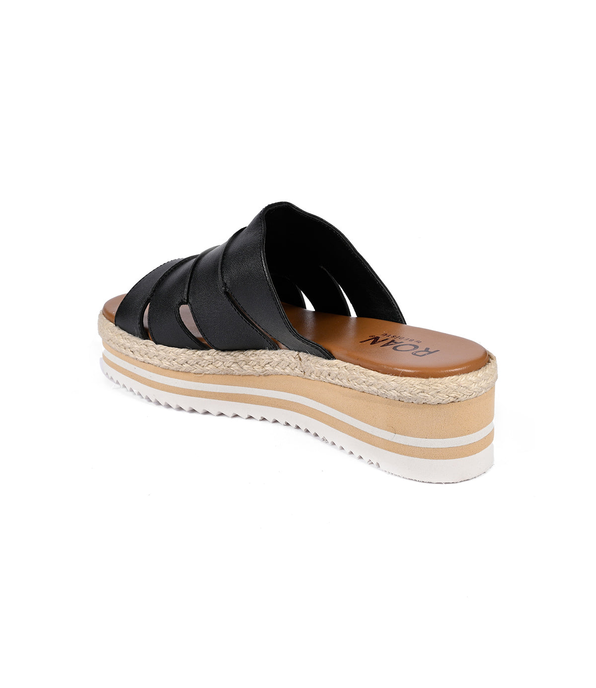 
                  
                    The Incant by Roan is a black platform slide sandal with crisscross straps, featuring a tan cushioned sole and a white ribbed platform bottom for a boho-chic look.
                  
                