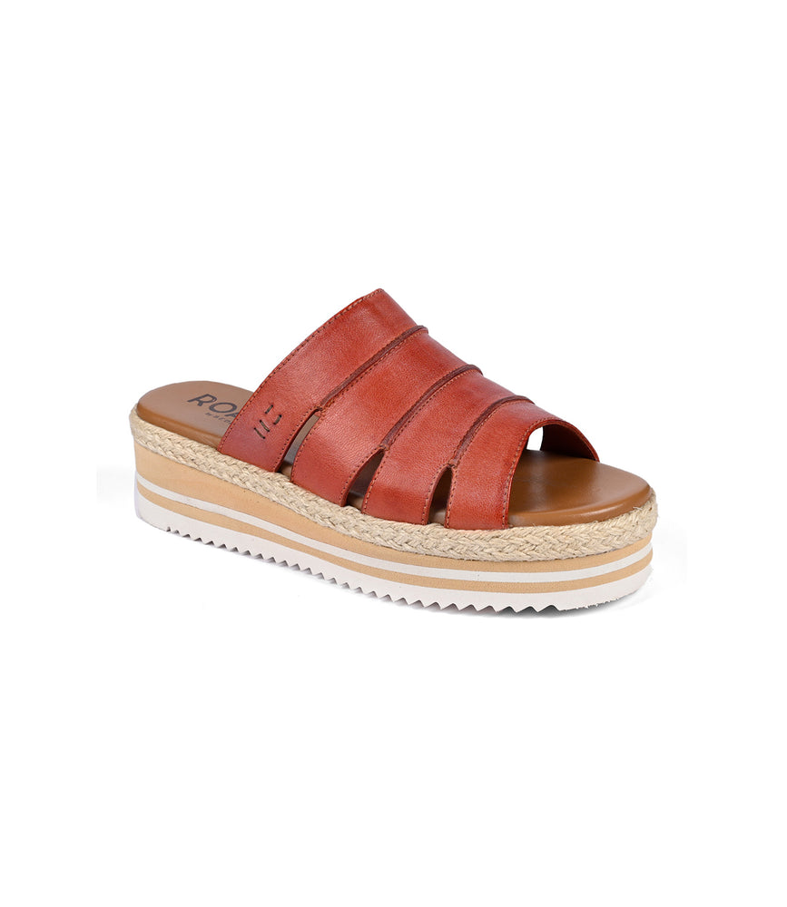 
                  
                    The Roan Incant is a brown platform slide sandal with leather straps, a white zigzag tread, and a tan cushioned footbed for added comfort.
                  
                