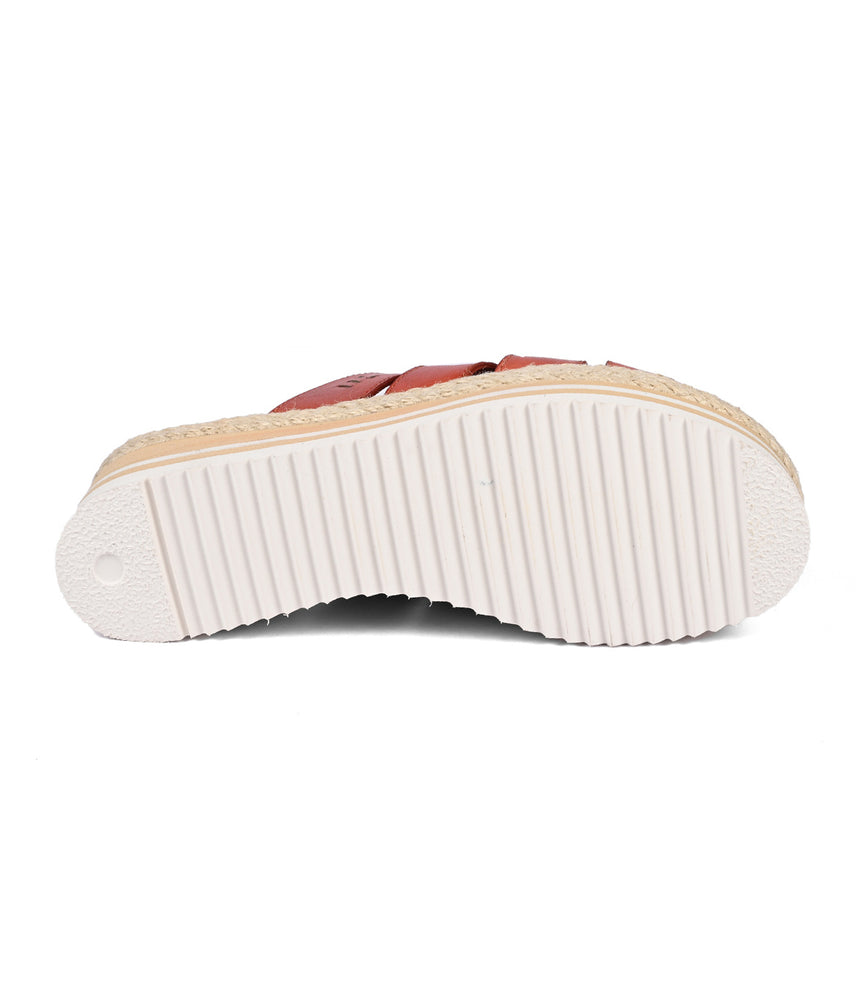 
                  
                    The image showcases the Incant platform slide sandal by Roan, featuring a white, ridged sole with a circular heel pattern that enhances its boho-chic charm.
                  
                