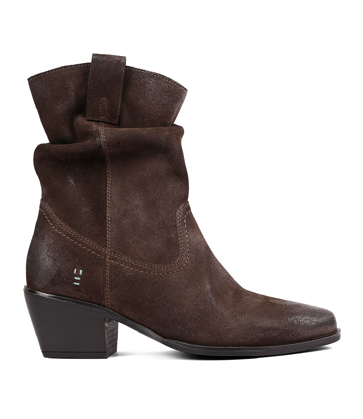 
                  
                    Roan’s “Interaction” ankle boot in brown suede features a pointed toe, mid-height block heel, slightly slouched shaft, and pull-on tab, shown in side profile on a white background.
                  
                