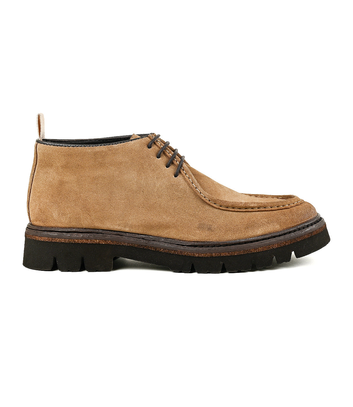 
                  
                    The Roan Kickoff chukka boot in tan suede features a moc-toe design, lace-up front, thick black rubber sole, visible stitching, and a pull tab at the heel, shown in a left-side profile view.
                  
                