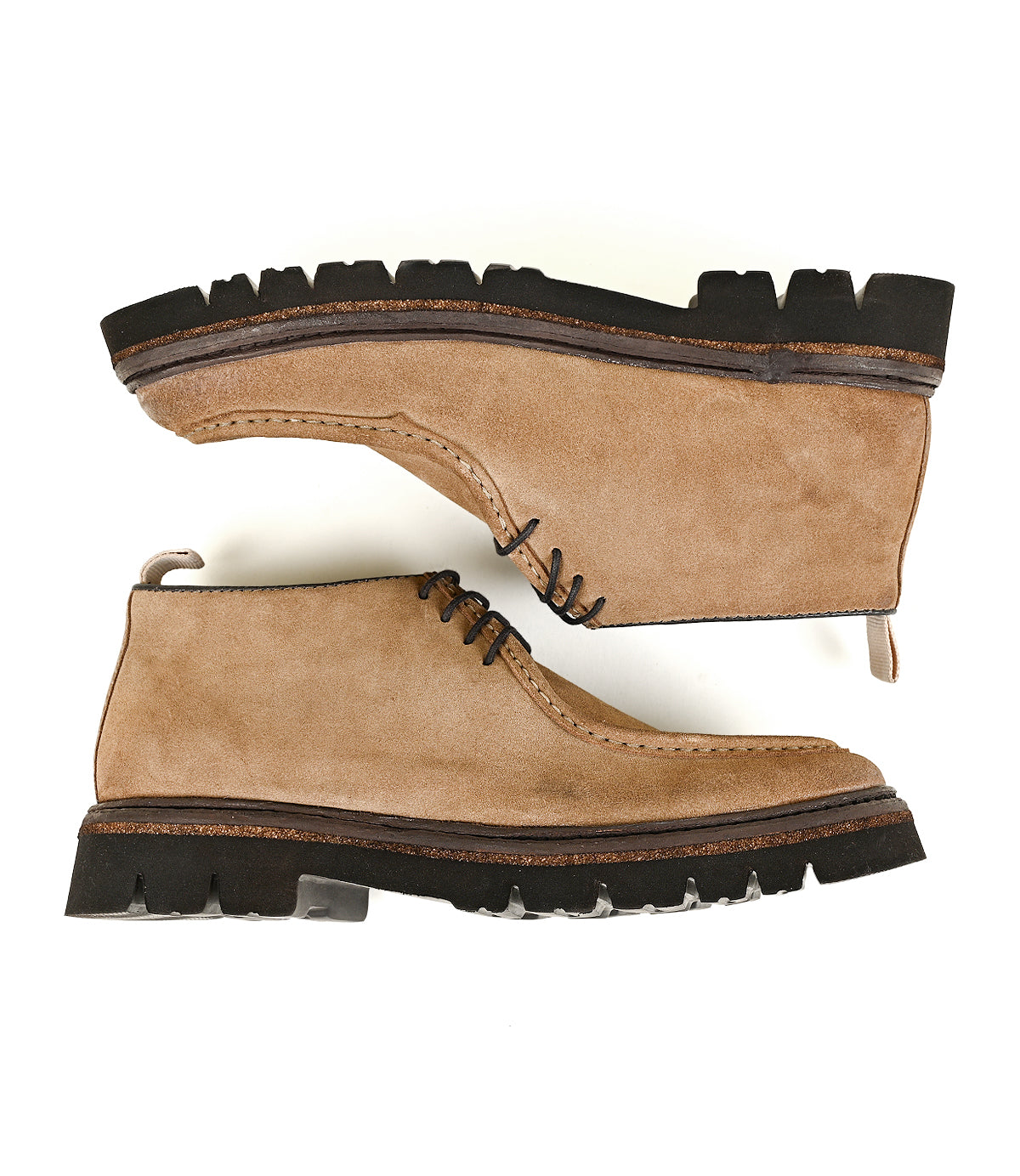 
                  
                    Kickoff chukka boots by Roan in tan suede, featuring thick black rubber soles and moc-toe detailing, displayed side-on against a white background.
                  
                