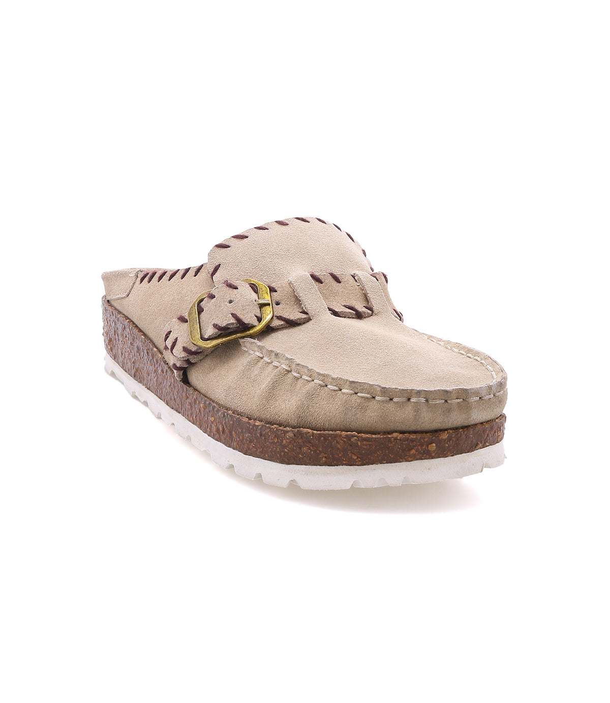 
                  
                    The Roan Mingle is a tan slip-on clog featuring a plush suede upper with visible stitching, a gold-tone buckle detail on the side, and a chunky cork-wrapped sole with a white outsole, shown against a white background.
                  
                