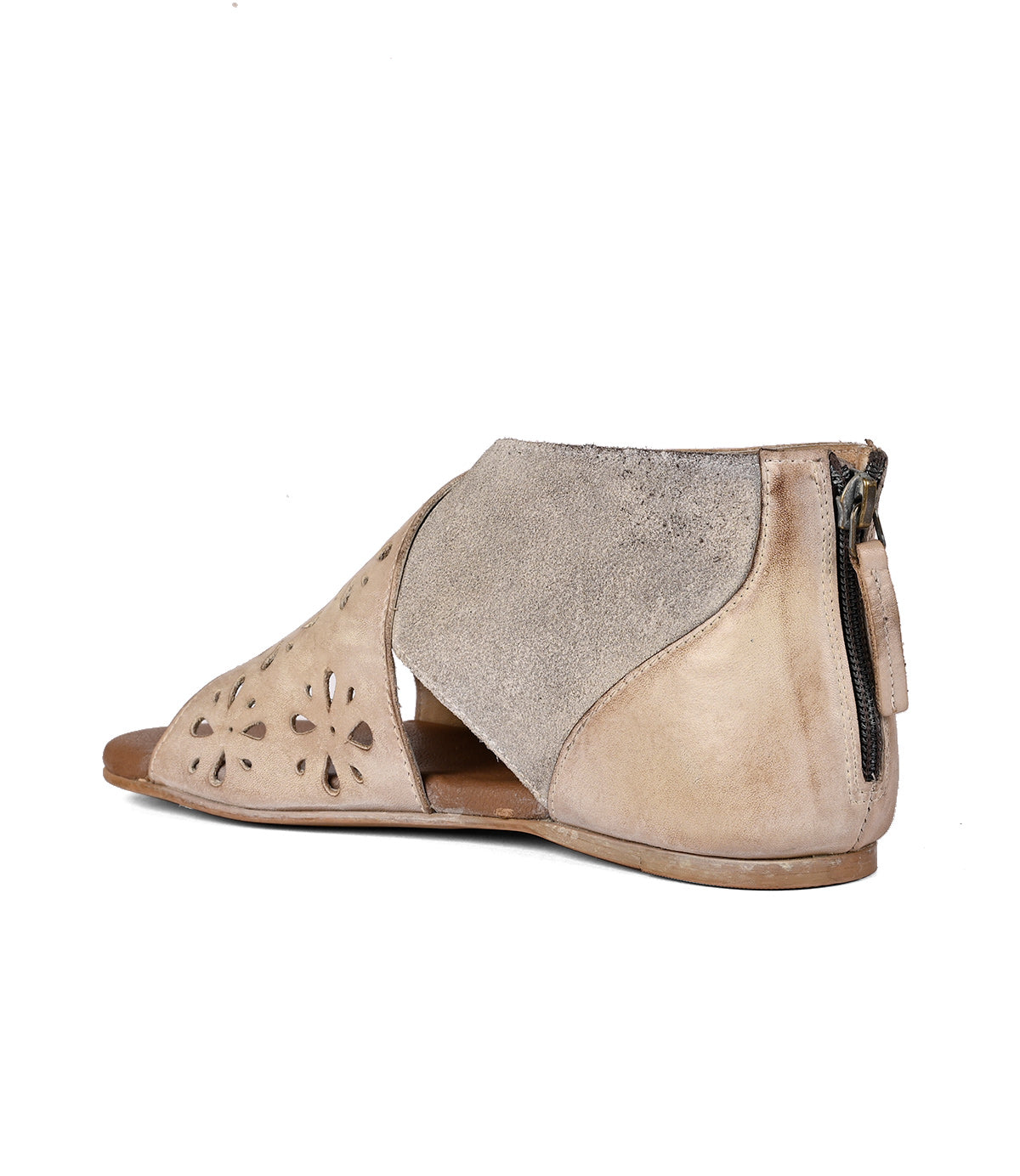 
                  
                    A beige suede Rotation peep-toe flat shoe by Roan with decorative laser-cut design and a zipper closure on the back, isolated on a white background.
                  
                