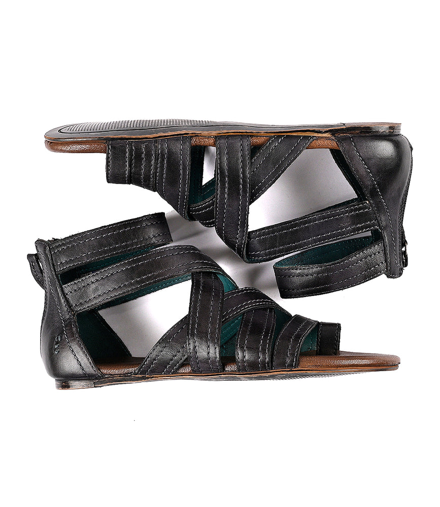 
                  
                    A pair of black leather Royalty sandals by Roan with a cushioned footbed.
                  
                