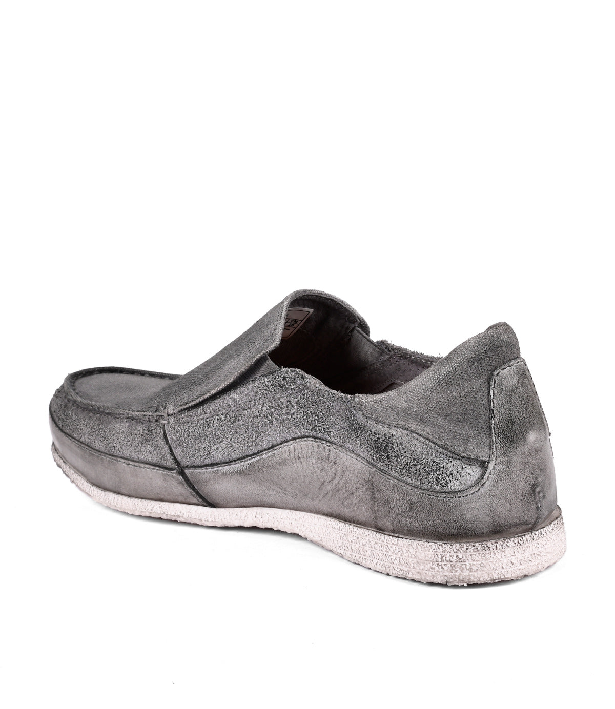 
                  
                    Single worn-out Shevon grey leather slip-on shoe on a white background by Roan.
                  
                