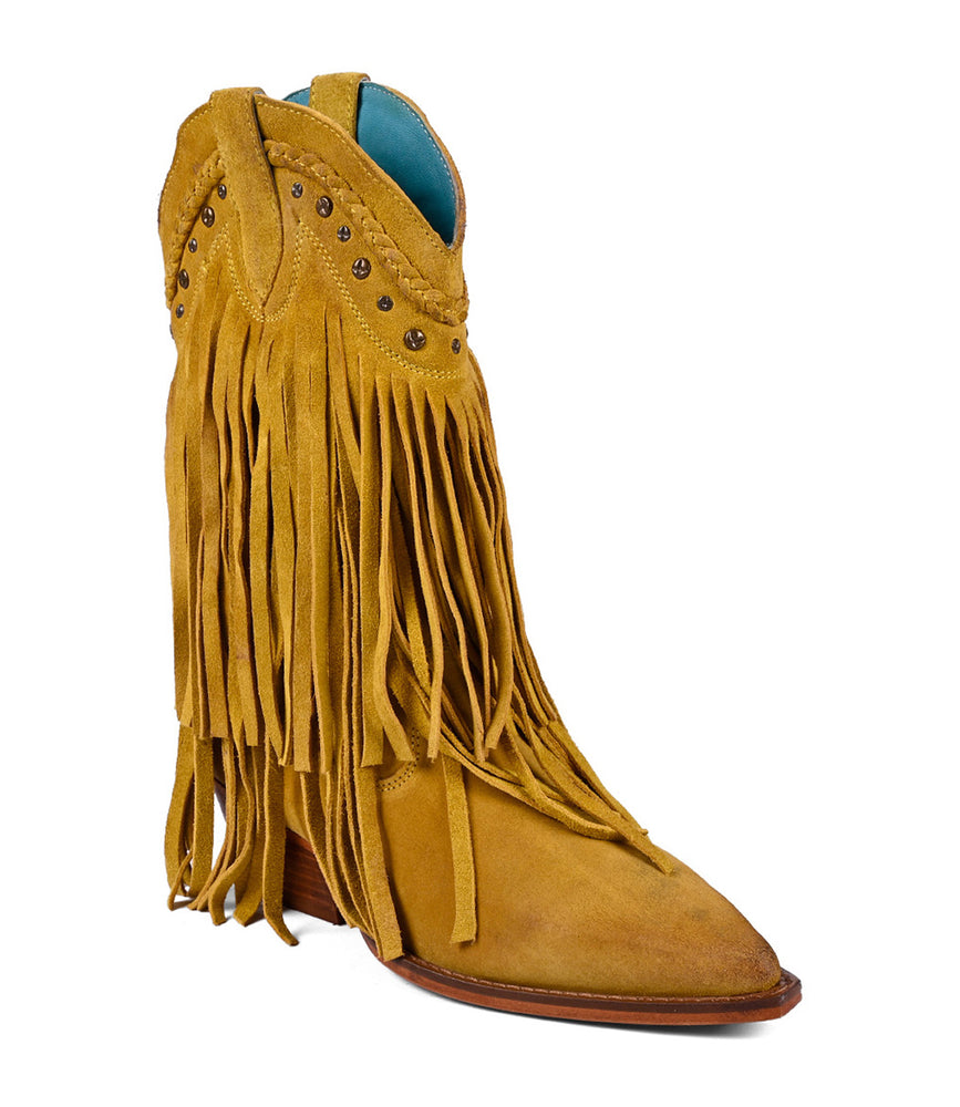 
                  
                    The Roan Setup boot, a Western-inspired design in premium suede, features yellow fringe, decorative studs, a pointed toe, and low stacked heel against a white background.
                  
                