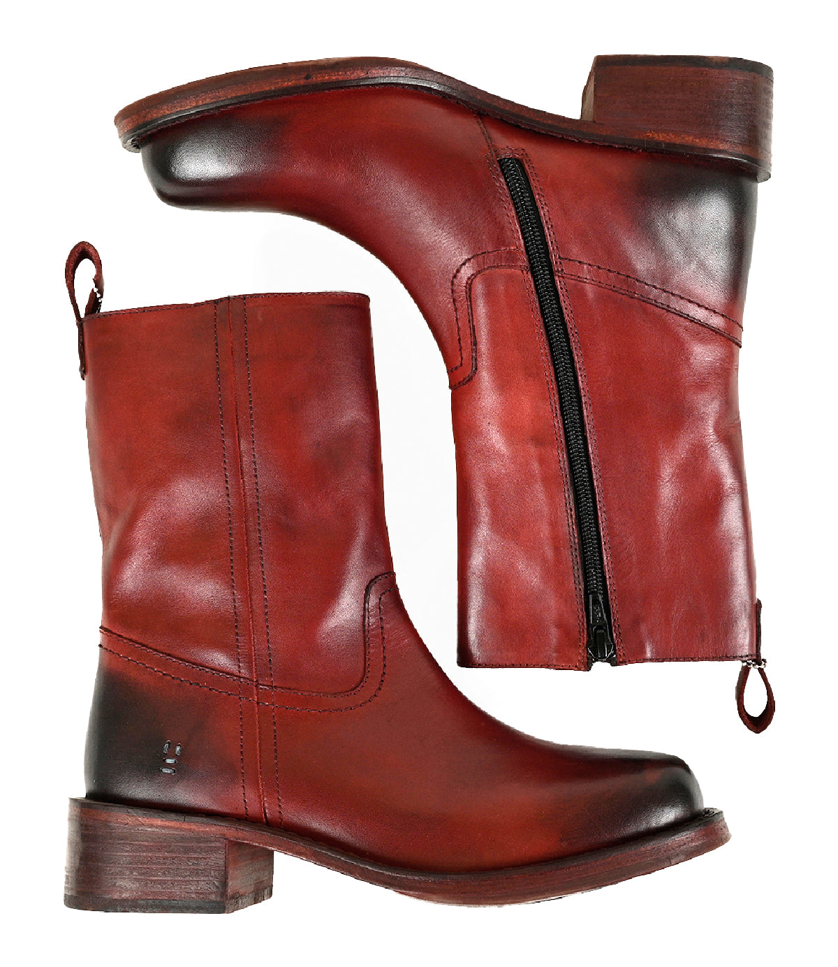 
                  
                    Shown are two “Splitter” boots by Roan in red-brown leather, featuring inner-ankle zippers, thick heels, and pull tabs; one boot stands upright while the other lies on its side, showcasing their chunky leather silhouette.
                  
                