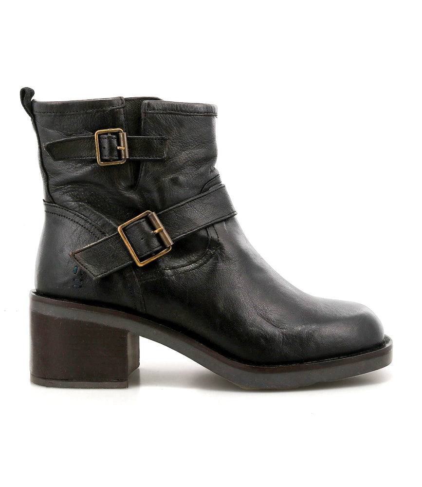 The Spry ankle boot by Roan is shown in profile facing left, featuring black hand-finished leather, double buckle straps, and a thick block heel for a moto-inspired look.