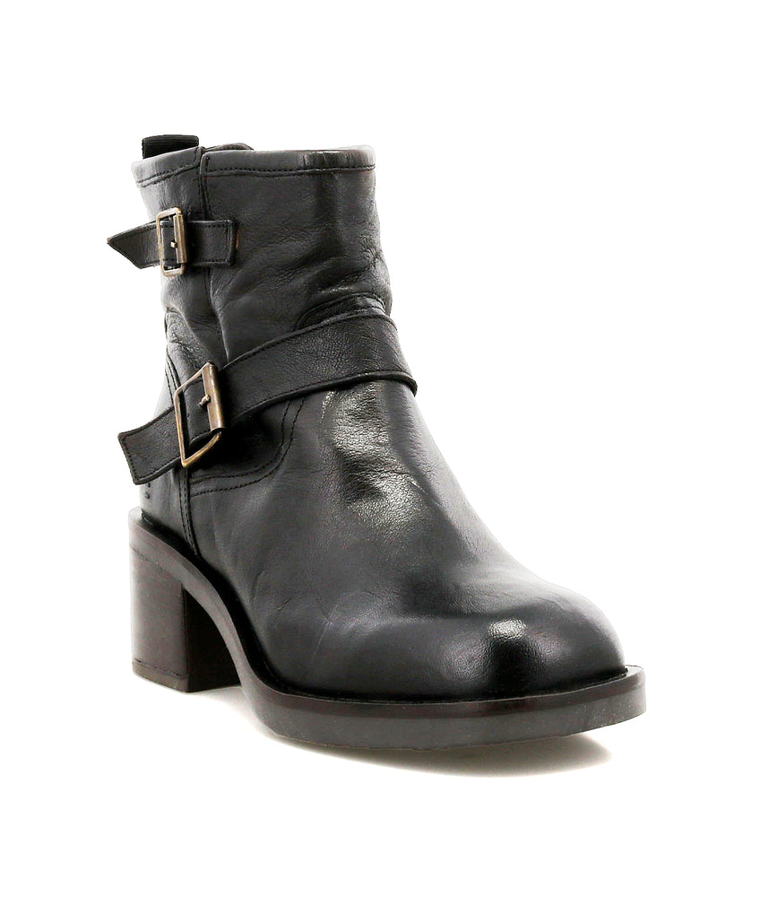 The Roan Spry is a moto-inspired ankle boot in hand-finished black leather with a chunky low heel and sleek double buckle strap, displayed on a white background.
