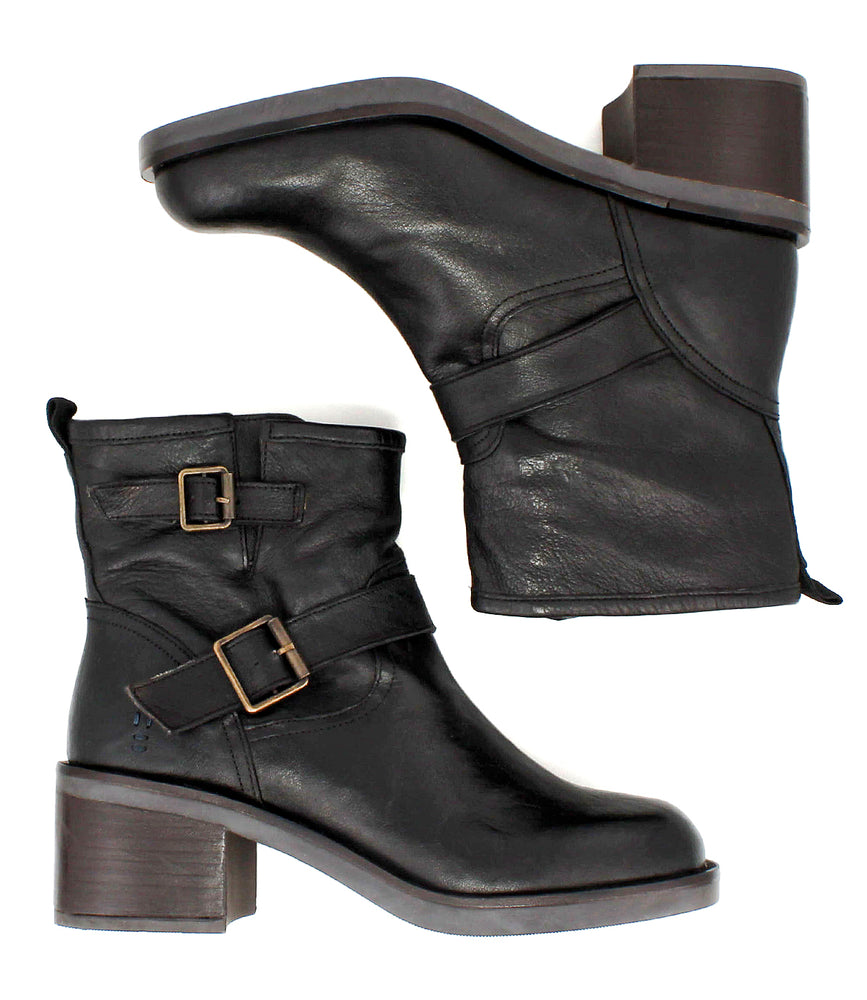 
                  
                    The Spry by Roan: moto-inspired black hand-finished leather ankle boots with chunky heels, double decorative buckle straps, and metal buckles, shown in side and top-down views.
                  
                