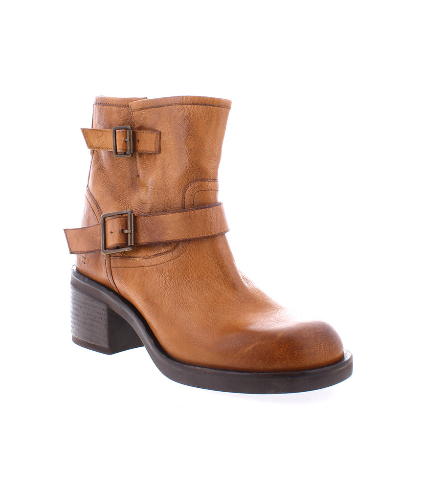 
                  
                    The Spry by Roan is a tan, hand-finished leather ankle boot with double buckle straps and a low block heel, shown on a plain white background.
                  
                