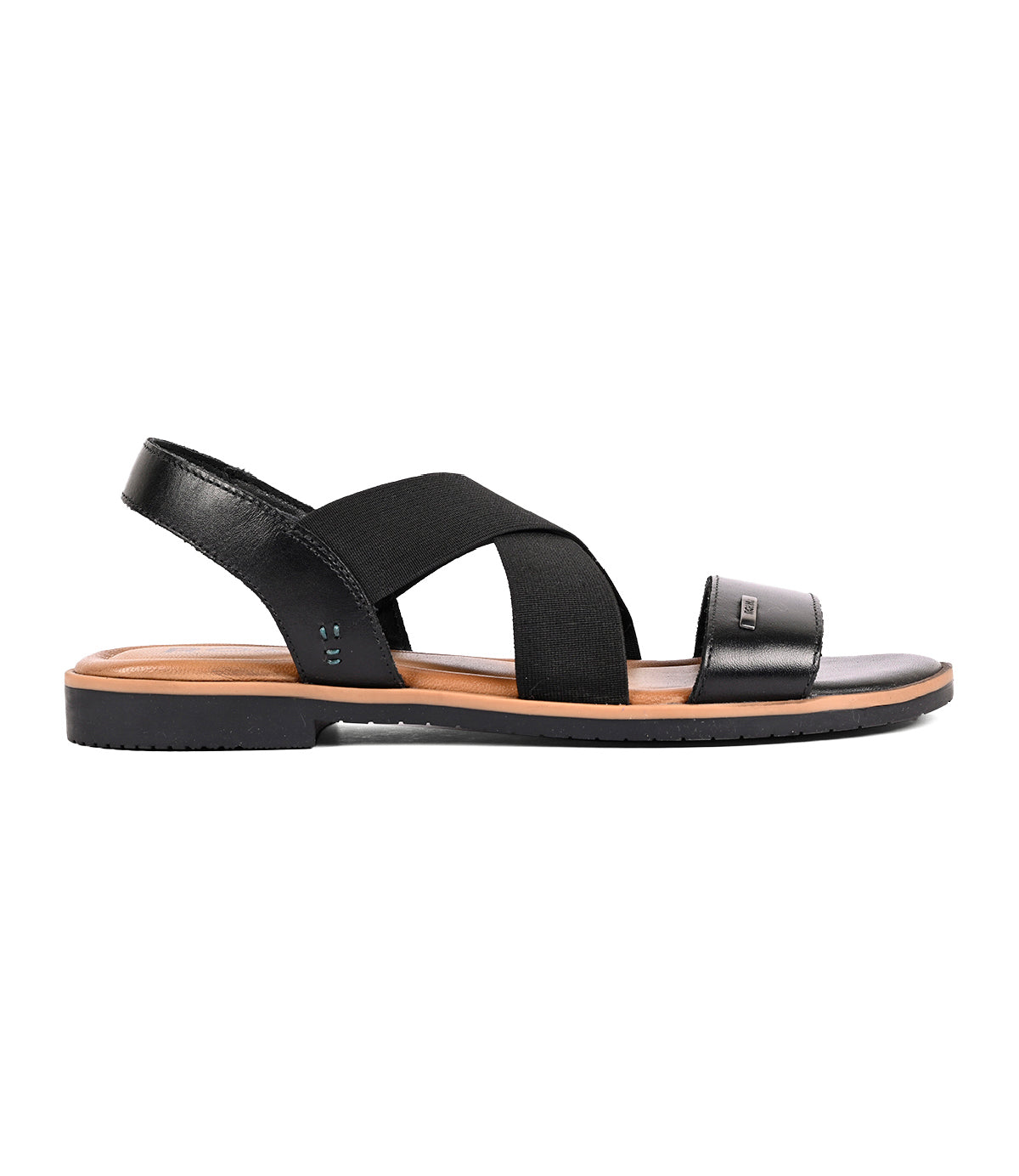 Theodora by Roan is a black leather sandal featuring elastic crossover straps, a closed heel strap, and an open toe for a comfortable fit, shown in side profile.