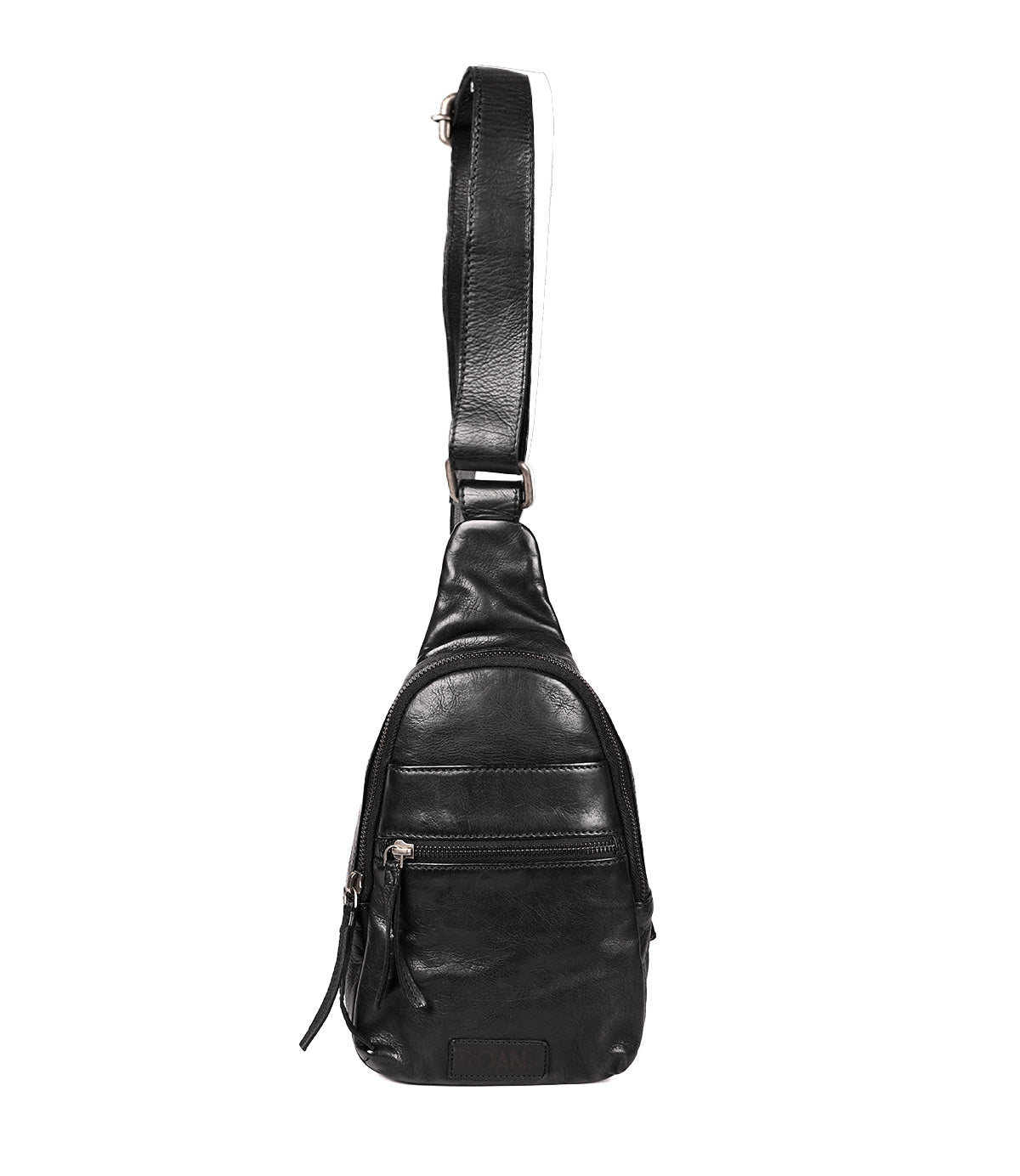 
                  
                    The Roan Trickle is a compact black leather sling satchel with multiple zippered compartments and an adjustable shoulder strap, photographed on a white background for everyday versatility.
                  
                