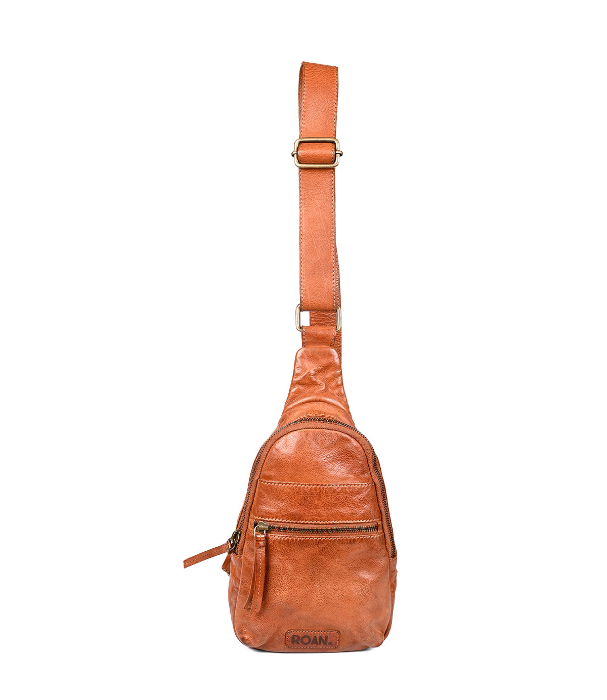 
                  
                    The Trickle by Roan is a compact brown leather bag with an adjustable crossbody strap, front zipper pockets, and an embossed "ROAM" logo—crafted for everyday versatility and effortless style.
                  
                