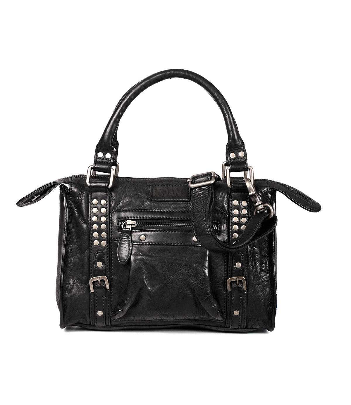 
                  
                    The Roan Visual is a black leather satchel with silver studded accents, a front zipper pocket, decorative buckles, and two carrying handles.
                  
                