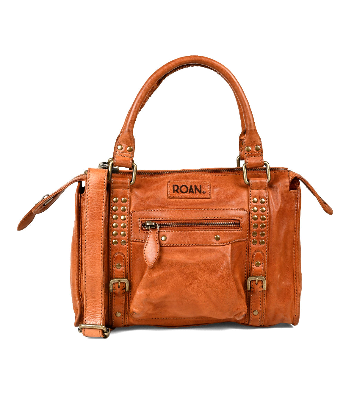 
                  
                    The Roan Visual is a brown leather satchel with dual handles, a detachable crossbody strap, a front zip pocket, and studded accents. The brand "Roan" is embossed above the front pocket.
                  
                
