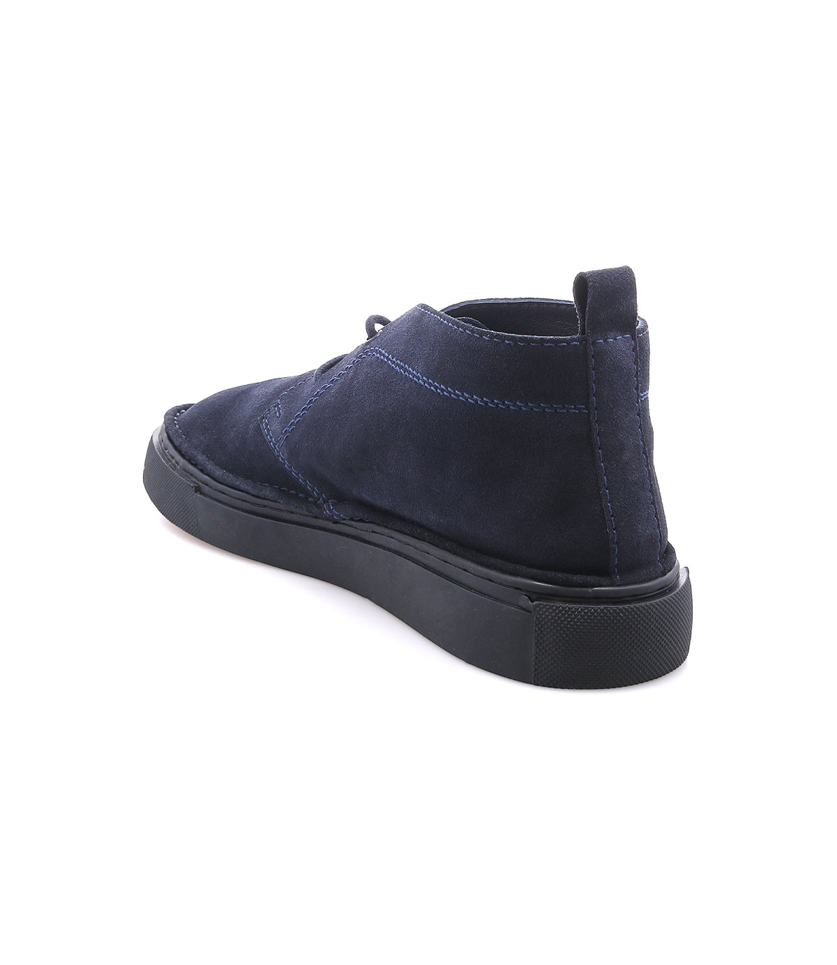 
                  
                    The Roan Volunteer features navy blue suede in a chukka style, complemented by a black sneaker-inspired sole and a subtle pull tab, shown from the back left angle against a white background.
                  
                