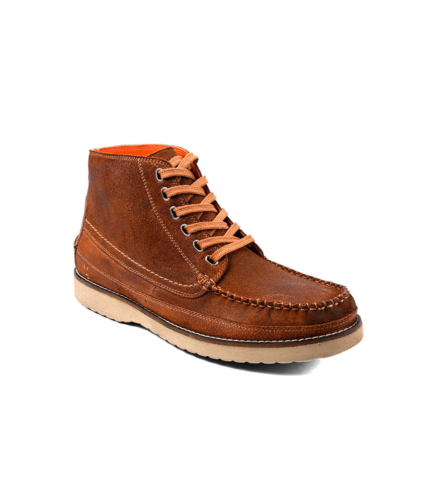 
                  
                    The Roan Warden is a brown leather moc toe chukka boot featuring contrast stitching, a cushioned insole, and a light-colored rubber sole, shown on a white background.
                  
                