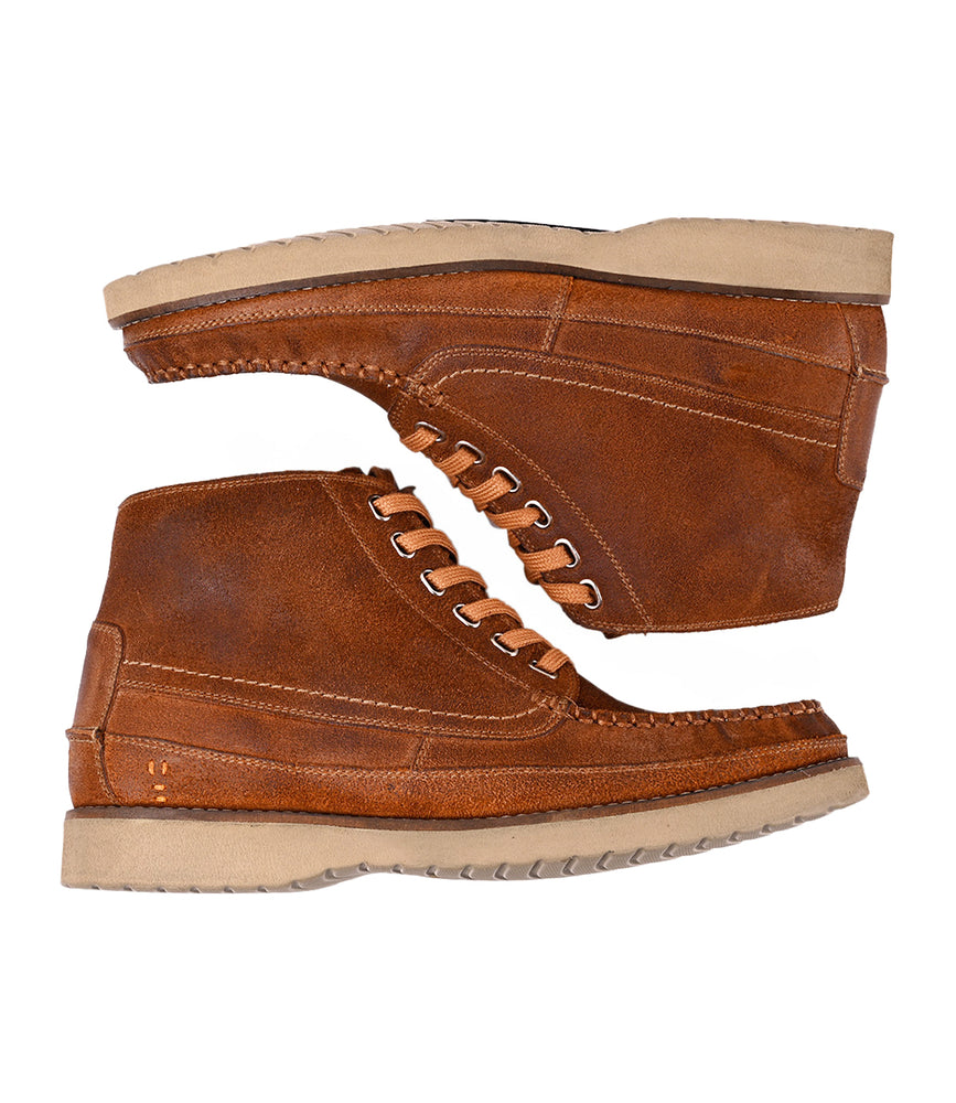 
                  
                    The Roan Warden boots, featuring brown leather and tan soles, are displayed side by side on a white background—one facing left, the other right.
                  
                