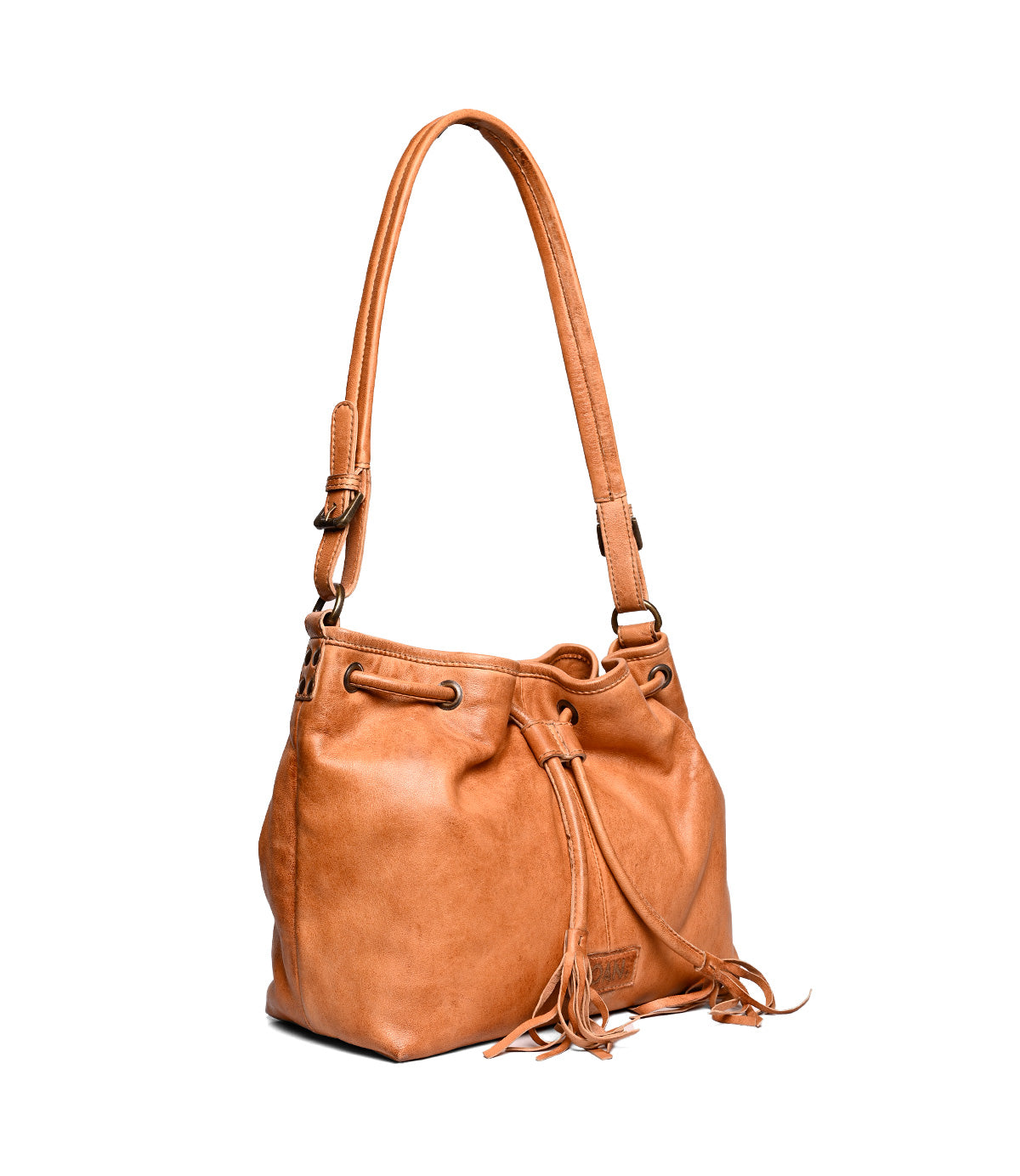 
                  
                    The Roan Zone tan cow suede leather bucket bag features a scrunch-style design, drawstring closure, long adjustable strap, and decorative tassels, shown against a white background.
                  
                