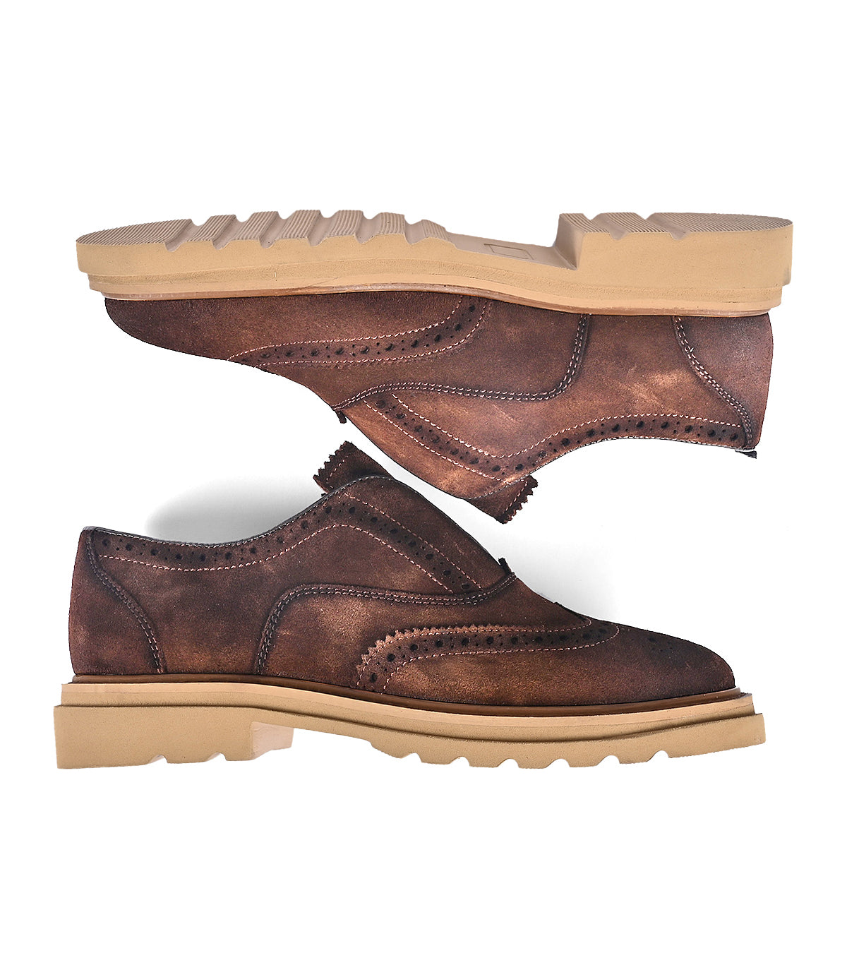 
                  
                    The "Blame" shoes by Roan are a pair of brown leather brogues with intricate detailing and tan chunky soles, showcased from the side and upside down.
                  
                