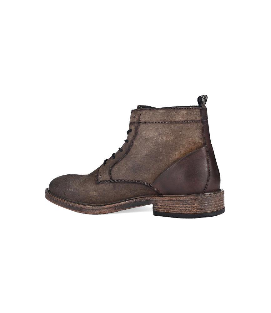 
                  
                    The Joyride by Roan is a brown lace-up ankle boot crafted from full-grain leather, featuring a thick sole and visible stitching, elegantly displayed from the side.
                  
                