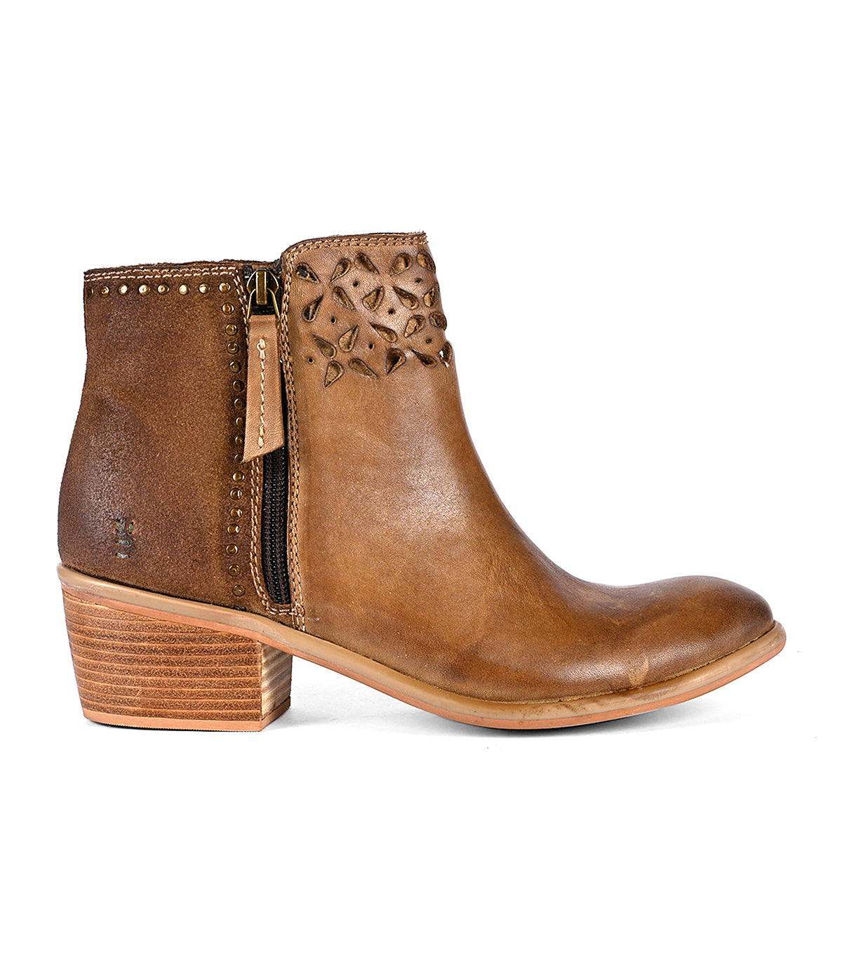 
                  
                    The Liz Cutout by Roan is a brown leather ankle boot featuring decorative cut-outs, a side zipper, gold rivet details around the top, and a wooden block heel.
                  
                