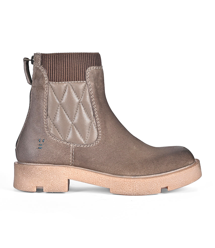 The "Thoughtful" brown ankle boot by Roan features a quilted side panel, sturdy sole, and ribbed elastic at the top, offering style versatility and comfort for any occasion.
