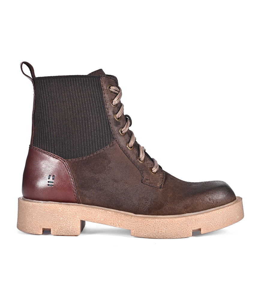 The Roan "Transform" features brown lace-up ankle boots with a chunky beige rubber sole, a ribbed black fabric section at the ankle, and a brown leather accent at the heel.